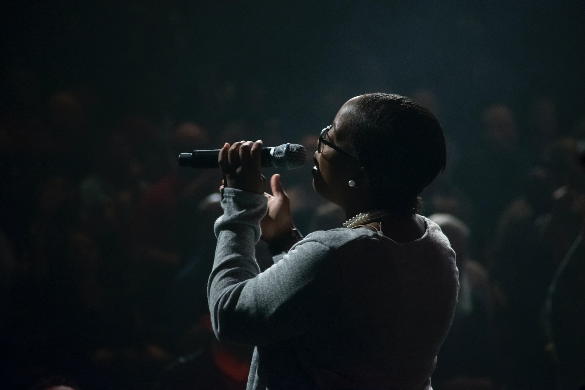 A person holding a microphone, symbolizing communication empowerment.