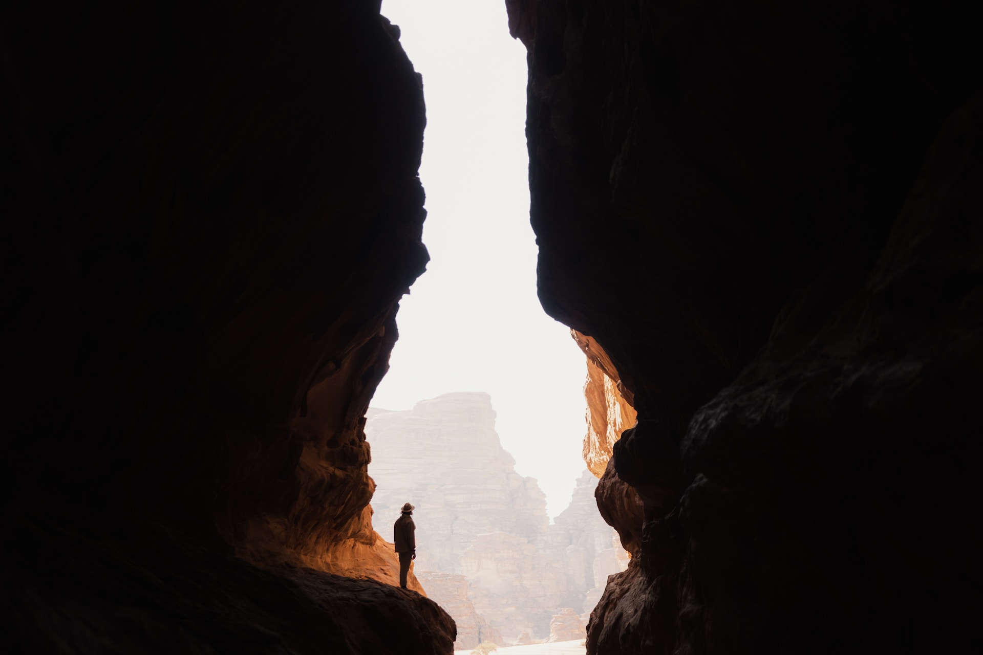 a man looking at nature's divide, contemplating his journey from achievement to fulfillment