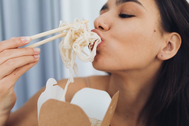 A candid shot of individuals savoring each bite, embracing the practice of mindful eating with genuine enjoyment.